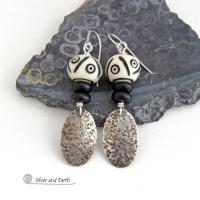 These handcrafted sterling silver earrings have a rustic, hand stamped texture and are accented with African carved bone and matte black agate beads. The bone beads have a bold, striking pattern of black circles and lines carved into a white base. Lightweight and fun to wear - they have an ethnic, tribal vibe and will make a unique statement.