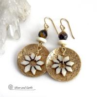 These handmade gold brass earrings have an ethnic bohemian style with an African inspired flair that makes a bold statement. They feature round brass dangles with a lightly hammered texture accented with African flower-shaped bone beads, faceted natural tiger's eye gemstones and African bone beads. Unique and fun to wear, they'll make a great gift for nature lovers and gardeners who love bohemian style jewelry. Handmade in the USA by Silver and Earth Jewelry. 