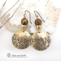 These handcrafted gold brass earrings feature a hand stamped leaf design and are accented with faceted tiger's eye gemstones and brass beads. They have an earthy, modern and elegant style that coordinates beautifully with all wardrobe types. They'll make a great gift for a nature lover - or a nice addition to your own jewelry wardrobe. These artisan-made earrings are perfect for adding a touch of earthy modern style to any outfit. 