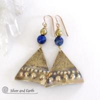 These handcrafted gold brass earrings have an exotic, Egyptian inspired vibe. The design consists of brass dangles with a hand textured design accented with faceted lapis lazuli gemstones and brass beads. Bold and unique - they'll make a striking statement. Perfect for women that love to wear eye-catching jewelry. Handmade in the USA by Silver and Earth Jewelry. 