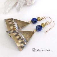 These handcrafted gold brass earrings have an exotic, Egyptian inspired vibe. The design consists of brass dangles with a hand textured design accented with faceted lapis lazuli gemstones and brass beads. Bold and unique - they'll make a striking statement. Perfect for women that love to wear eye-catching jewelry. Handmade in the USA by Silver and Earth Jewelry. 