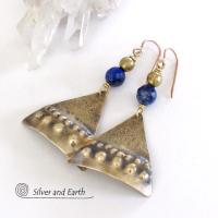 These handcrafted gold brass earrings have an exotic, Egyptian inspired vibe. The design consists of brass dangles with a hand textured design accented with faceted lapis lazuli gemstones and brass beads. Bold and unique - they'll make a striking statement. Perfect for women that love to wear eye-catching jewelry. Handmade in the USA by Silver and Earth Jewelry. 