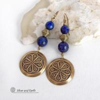 These handcrafted gold brass earrings have an exotic, Egyptian inspired vibe. They feature brass circle dangles with a beautiful embossed texture accented with faceted genuine lapis lazuli gemstones and textured brass beads. Bold and unique, they'll add a touch of cultural exotic charm to any type of wardrobe - dressed up or down. Perfect for women that love unique artisan handcrafted jewelry. Handmade in the USA by Silver and Earth Jewelry. 