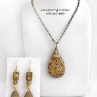 These handcrafted earrings feature gold brass teardrop dangles with a lightly hammered organic texture accented with natural picture jasper stones, brass and fossilized beige coral beads. They have an earthy natural style that coordinates beautifully with all wardrobe styles. Earrings have a coordinating necklace sold separately. Handmade in the USA by Silver and Earth Jewelry.