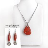 Simple and earthy - this pendant necklace features a natural red jasper gemstone with a wire wrapped sterling silver bail. The stone has a brick red hue with a natural matrix of beige streaks and dots. It has a modern minimalist appeal and is perfect for those that prefer simple, earthy jewelry. It has coordinating earrings which are sold separately. It makes a great gift for a natural stone lover - or a nice addition to your own jewelry wardrobe. Handmade in the USA by Silver and Earth Jewelry. 