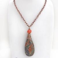 This handcrafted pendant necklace features a natural rhyolite jasper stone wire wrapped in copper wire and accented with a nugget-shaped coral bead. It has a natural pattern in several shades of earthy green along with splashes of orange. It has an earthy, casual boho style and is perfect for anyone that loves natural stones. It comes on an 18” copper chain with sturdy hook & eye closure; which can be removed from the pendant and worn alone or with other pendants in your wardrobe.