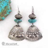 These handcrafted earrings feature uniquely textured sterling silver accented with natural turquoise gemstones and oxidized sterling silver beads with a rich, corrugated texture. They have a modern, southwestern tribal flair that makes a bold statement. Handmade in the USA by Silver and Earth Jewelry, a New Mexico True Certified business. 