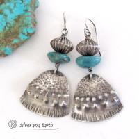 These handcrafted earrings feature uniquely textured sterling silver accented with natural turquoise gemstones and oxidized sterling silver beads with a rich, corrugated texture. They have a modern, southwestern tribal flair that makes a bold statement. Handmade in the USA by Silver and Earth Jewelry, a New Mexico True Certified business. 