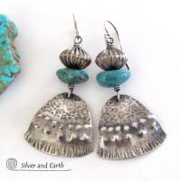 These handcrafted earrings feature uniquely textured sterling silver accented with natural turquoise gemstones and oxidized sterling silver beads with a rich, corrugated texture. They have a modern, southwestern tribal flair that makes a bold statement. Handmade in the USA by Silver and Earth Jewelry, a New Mexico True Certified business. 