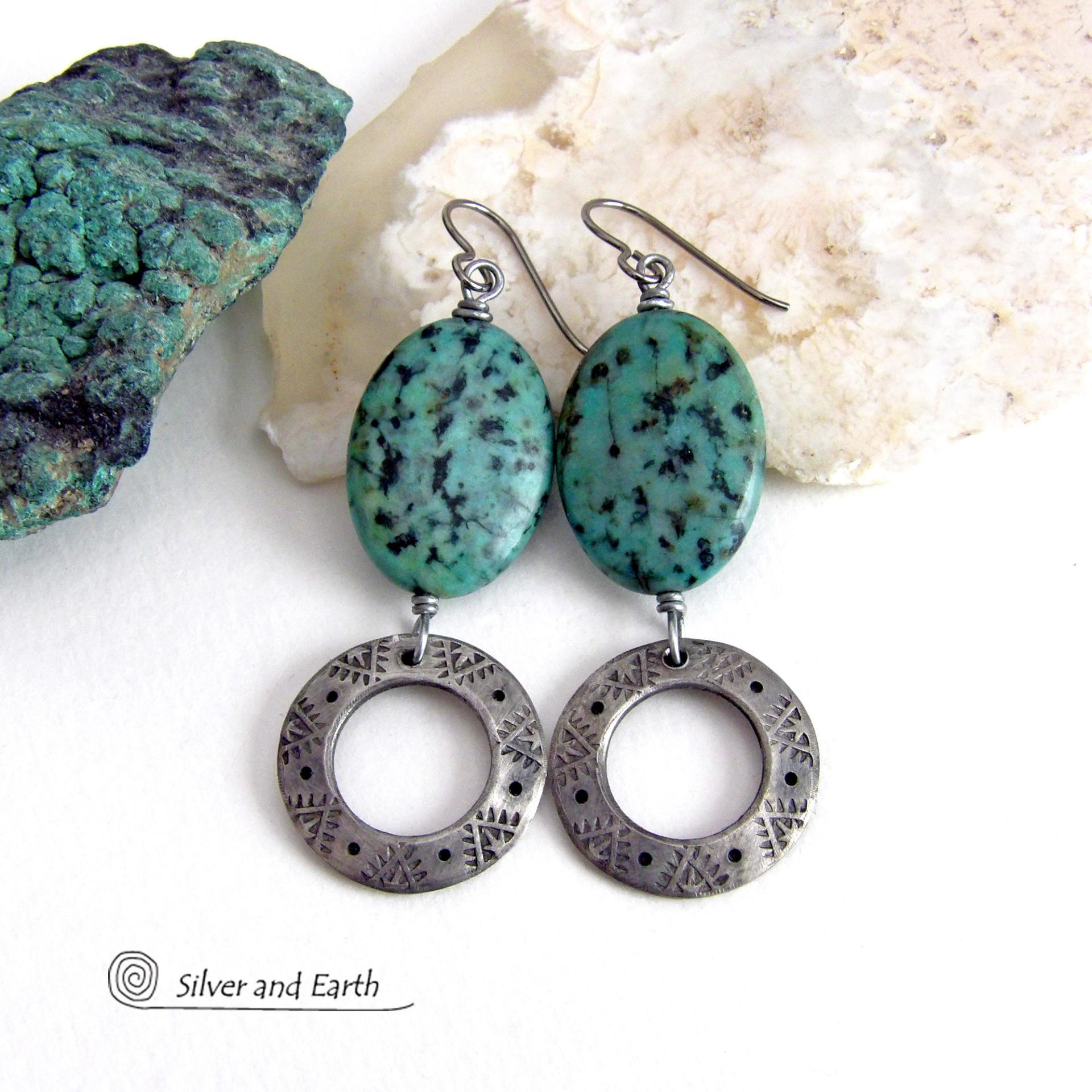 These handcrafted earrings feature natural African turquoise stones accented with silver tone pewter dangles with a hand stamped texture and oxidized finish. They have an earthy, modern style with a touch of southwestern flair. They have a coordinating necklace that is sold separately. Handmade in the USA by Silver and Earth Jewelry. 
