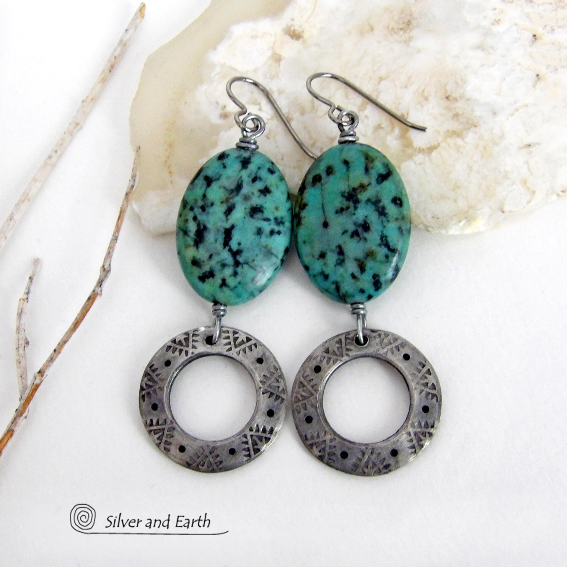 These handcrafted earrings feature natural African turquoise stones accented with silver tone pewter dangles with a hand stamped texture and oxidized finish. They have an earthy, modern style with a touch of southwestern flair. They have a coordinating necklace that is sold separately. Handmade in the USA by Silver and Earth Jewelry. 
