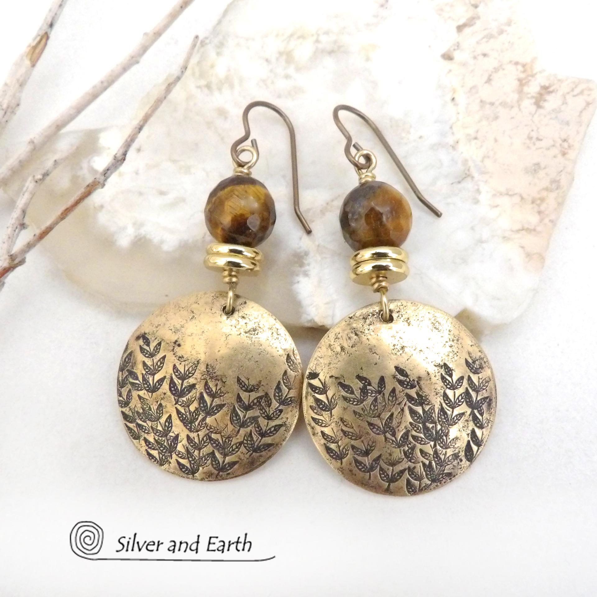 These handcrafted gold brass earrings feature a hand stamped leaf design and are accented with faceted tiger's eye gemstones and brass beads. They have an earthy, modern and elegant style that coordinates beautifully with all wardrobe types. They'll make a great gift for a nature lover - or a nice addition to your own jewelry wardrobe. These artisan-made earrings are perfect for adding a touch of earthy modern style to any outfit. 