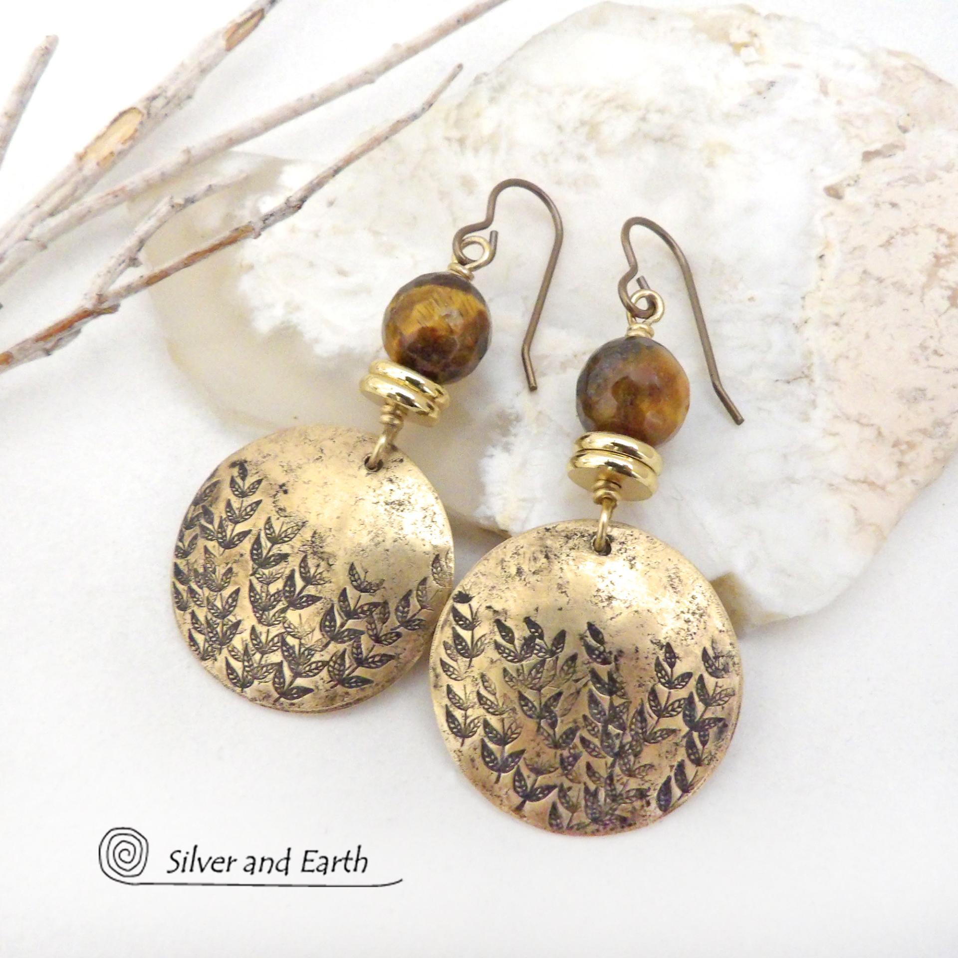These handcrafted gold brass earrings feature a hand stamped leaf design and are accented with faceted tiger's eye gemstones and brass beads. They have an earthy, modern and elegant style that coordinates beautifully with all wardrobe types. They'll make a great gift for a nature lover - or a nice addition to your own jewelry wardrobe.
