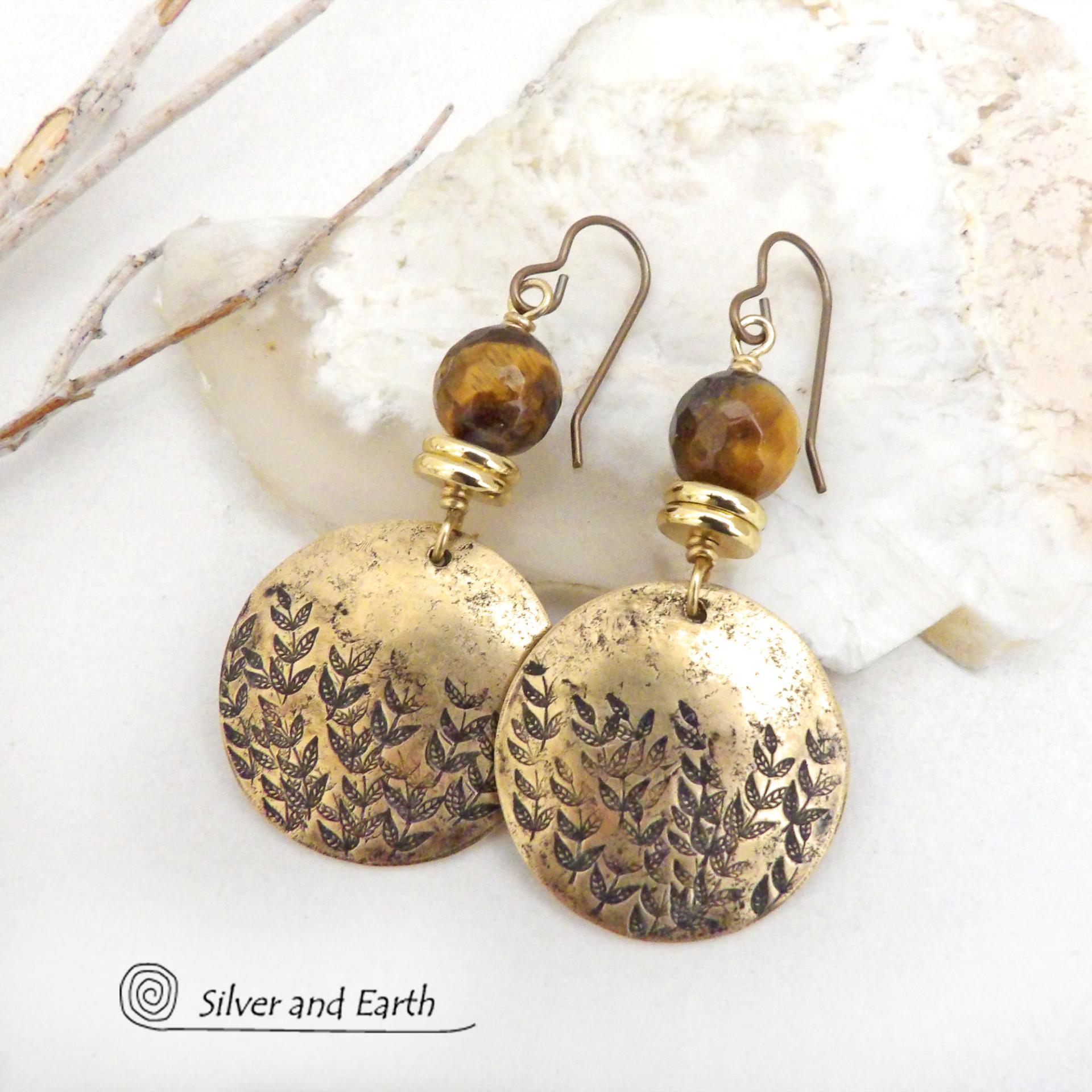 These handcrafted gold brass earrings feature a hand stamped leaf design and are accented with faceted tiger's eye gemstones and brass beads. They have an earthy, modern and elegant style that coordinates beautifully with all wardrobe types. They'll make a great gift for a nature lover - or a nice addition to your own jewelry wardrobe. These artisan-made earrings are perfect for adding a touch of earthy modern style to any outfit. 