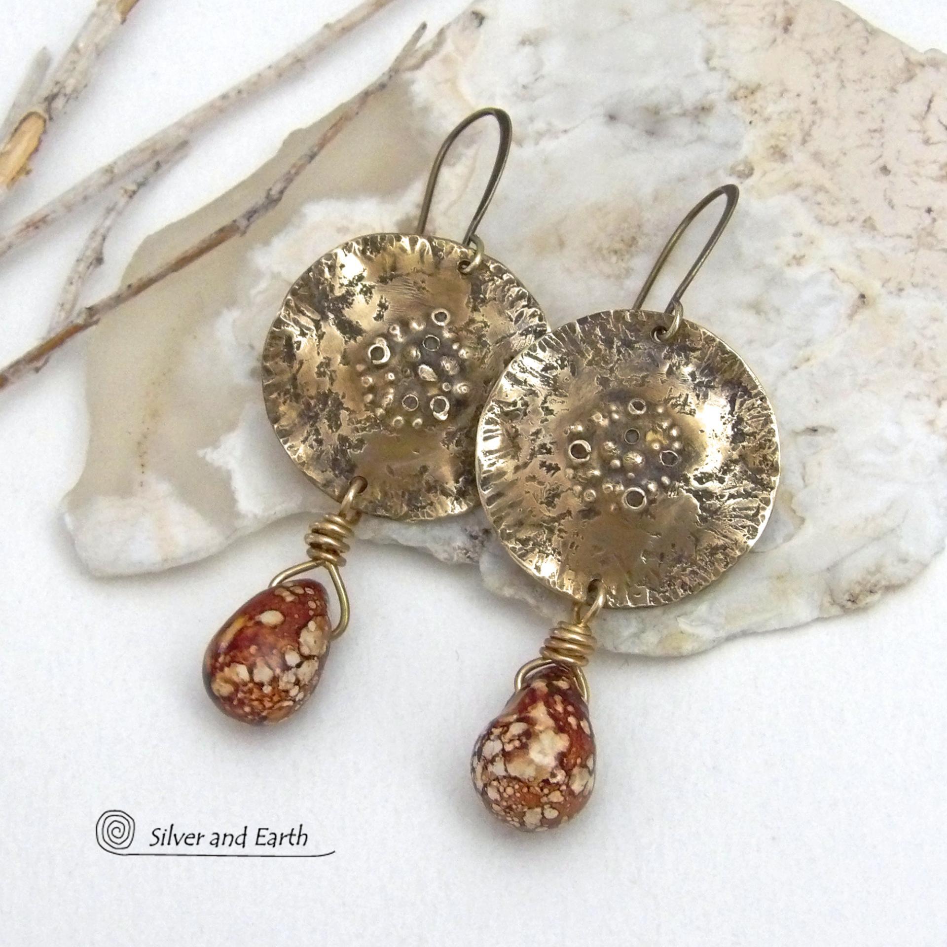 These handcrafted gold brass earrings have a modern, organic earthy style and are accented with natural brown spotted jasper gemstones. Bold, unique and one-of-a-kind - they make a striking statement with a modern edgy vibe. Perfect for women that love unique artisan handcrafted jewelry, earthy hammered textures and natural stones. Handmade in the USA by Silver and Earth Jewelry.