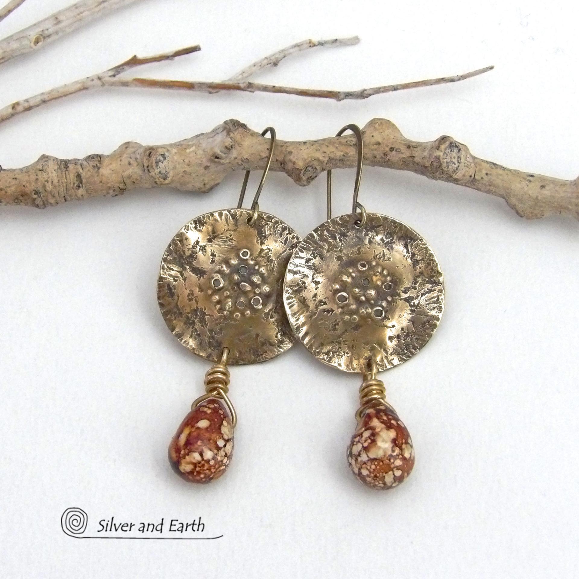 These handcrafted gold brass earrings have a modern, organic earthy style and are accented with natural brown spotted jasper gemstones. Bold, unique and one-of-a-kind - they make a striking statement with a modern edgy vibe. Perfect for women that love unique artisan handcrafted jewelry, earthy hammered textures and natural stones. Handmade in the USA by Silver and Earth Jewelry.