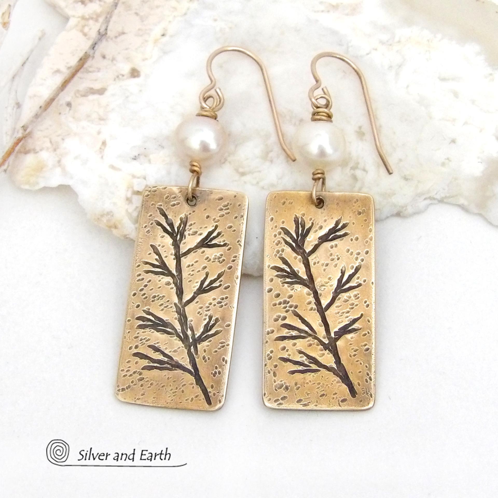 These artisan handmade earrings feature handcrafted gold brass rectangles with a hand stamped twig design accented with white pearls. They have a modern, earthy and elegant style and will make a great gift for a nature lover. They'll also make a great gift for someone born in June. Pearl is the traditional gemstone for this month. 