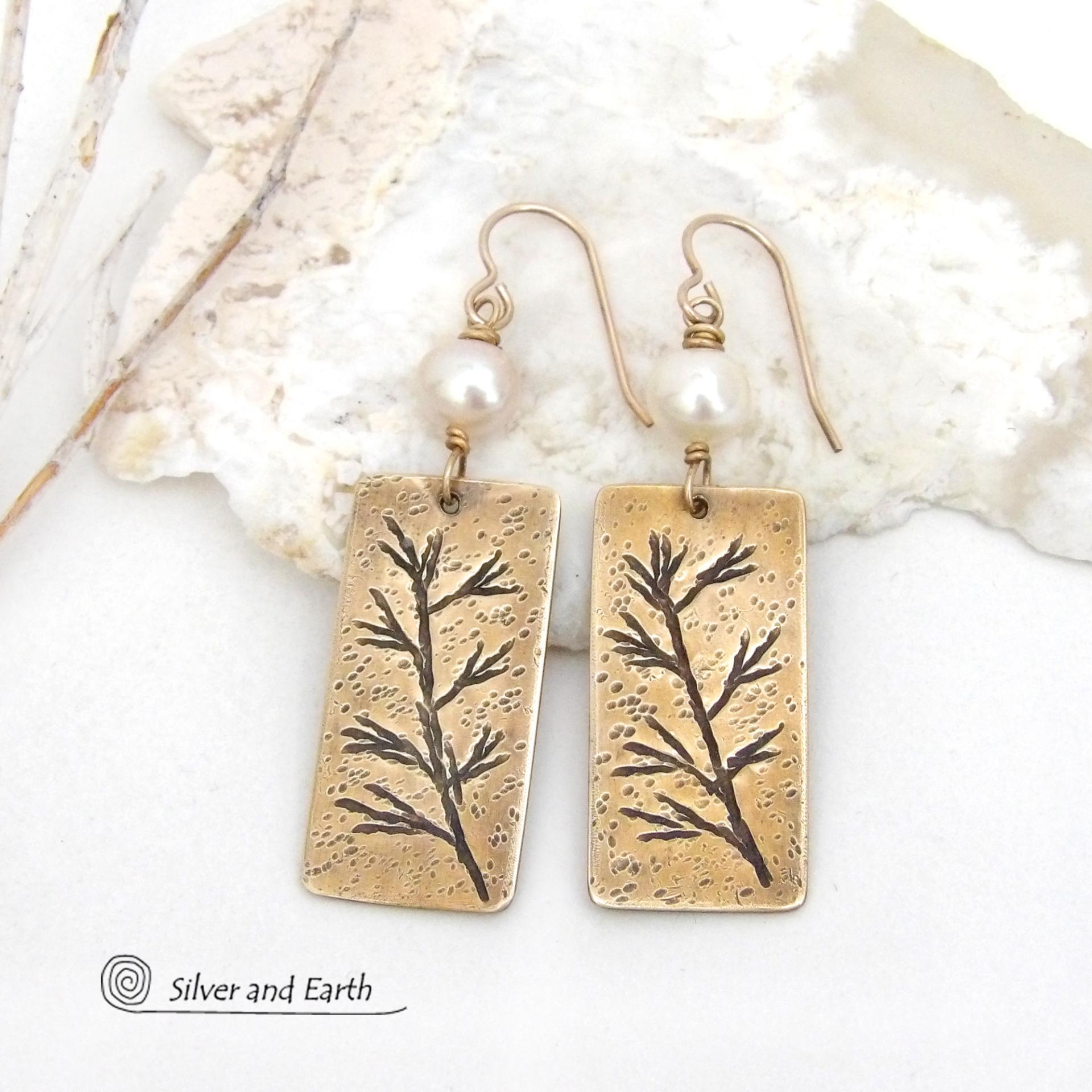 These artisan handmade earrings feature handcrafted gold brass rectangles with a hand stamped twig design accented with white pearls. They have a modern, earthy and elegant style and will make a great gift for a nature lover. They'll also make a great gift for someone born in June. Pearl is the traditional gemstone for this month. 