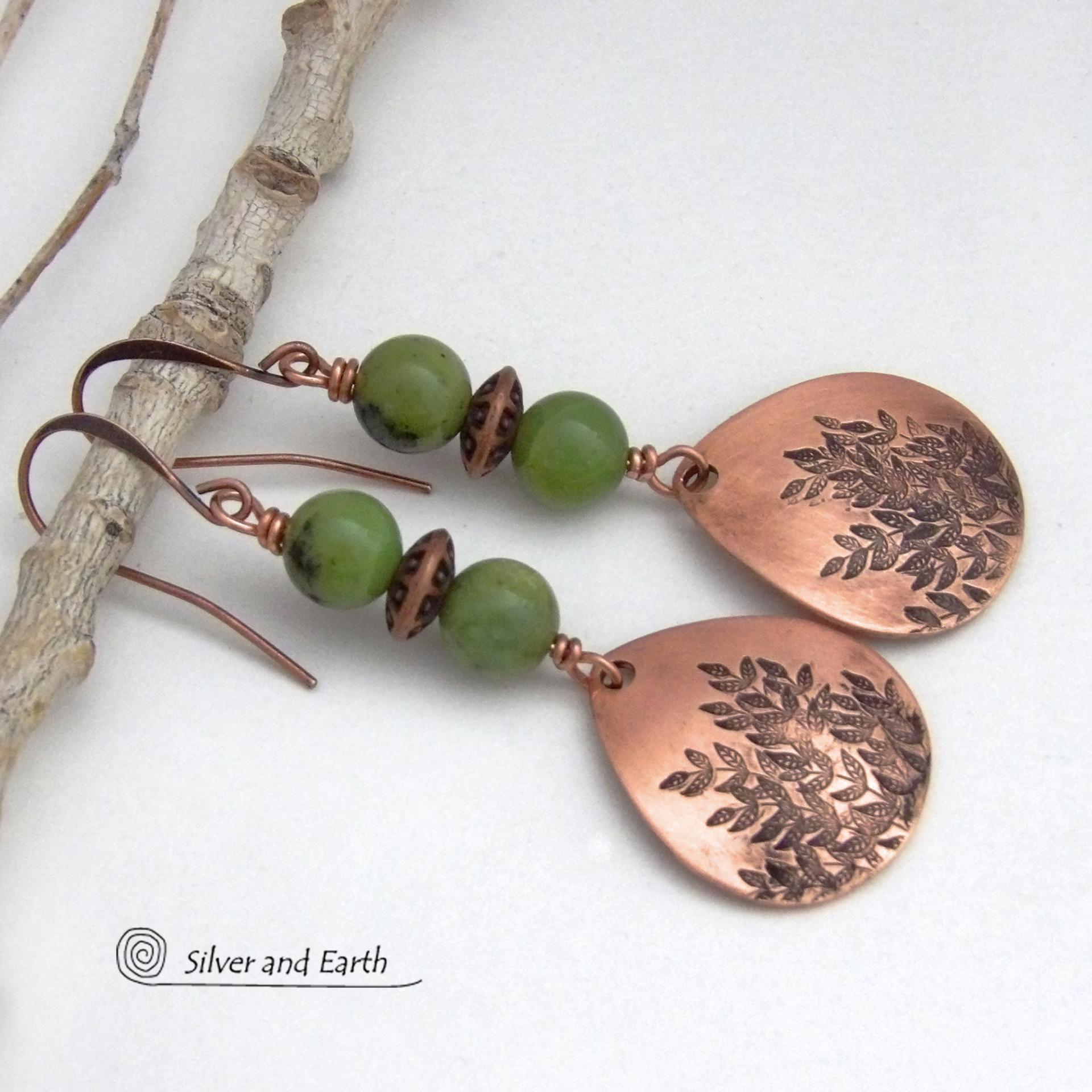 These handcrafted earrings feature teardrop shaped copper dangles with a hand-stamped leaf texture accented with natural green jade gemstones and copper beads. They have an earthy, modern style that coordinates well with all wardrobe styles. They'll make a great gift for a nature lover - or a nice addition to your own jewelry wardrobe. Your choice of copper ear wires or niobium hypoallergenic ear wires. Earrings are handmade in the USA by Silver and Earth Jewelry. 