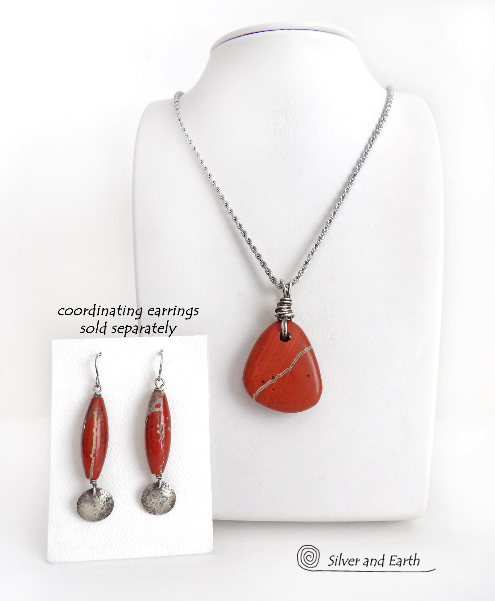 Simple and earthy - this pendant necklace features a natural red jasper gemstone with a wire wrapped sterling silver bail. The stone has a brick red hue with a natural matrix of beige streaks and dots. It has a modern minimalist appeal and is perfect for those that prefer simple, earthy jewelry. It has coordinating earrings which are sold separately. It makes a great gift for a natural stone lover - or a nice addition to your own jewelry wardrobe. Handmade in the USA by Silver and Earth Jewelry. 