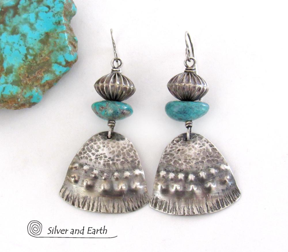 These handcrafted earrings feature uniquely textured sterling silver accented with natural turquoise gemstones and oxidized sterling silver beads with a rich, corrugated texture. They have a modern, southwestern tribal flair that makes a bold statement. Handmade in the USA by Silver and Earth Jewelry, a New Mexico True Certified business. 