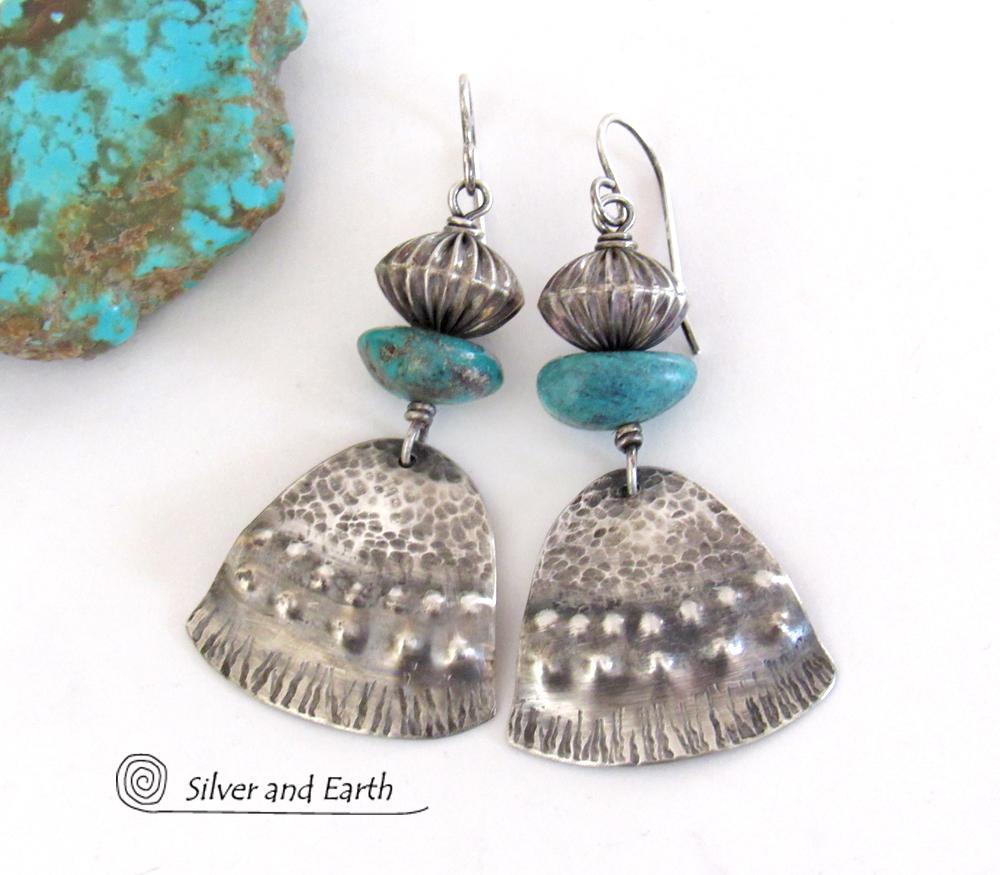 These handcrafted earrings feature uniquely textured sterling silver accented with natural turquoise gemstones and oxidized sterling silver beads with a rich, corrugated texture. They have a modern, southwestern tribal flair that makes a bold statement. Handmade in the USA by Silver and Earth Jewelry, a New Mexico True Certified business. 