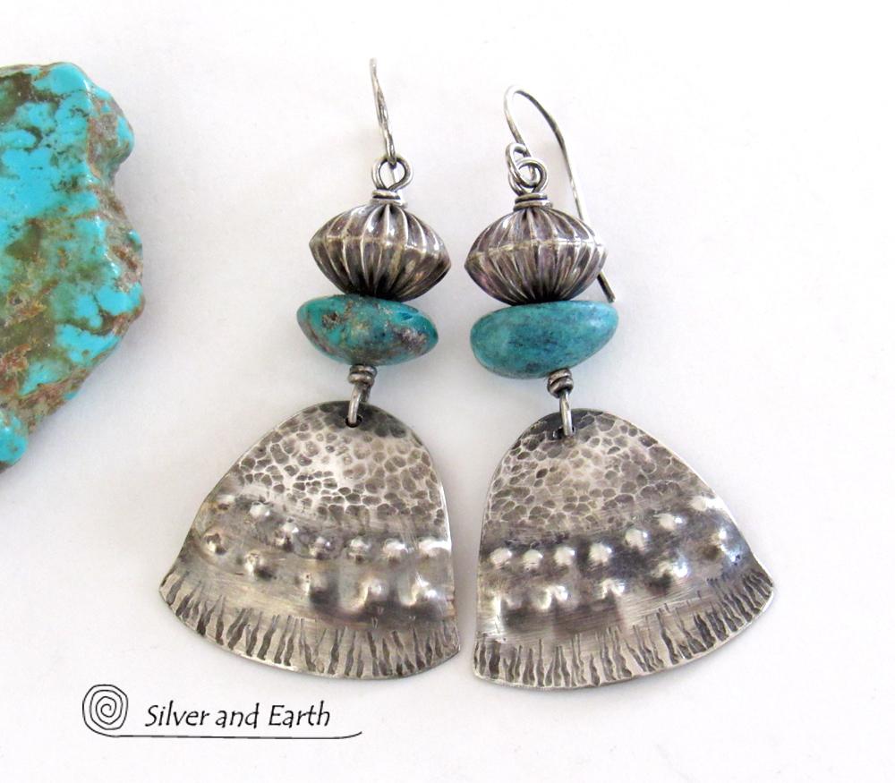 These handcrafted earrings feature uniquely textured sterling silver accented with natural turquoise gemstones and oxidized sterling silver beads with a rich, corrugated texture. They have a modern, southwestern tribal flair that makes a bold statement. Handmade in the USA by Silver and Earth Jewelry, a New Mexico True Certified business. 