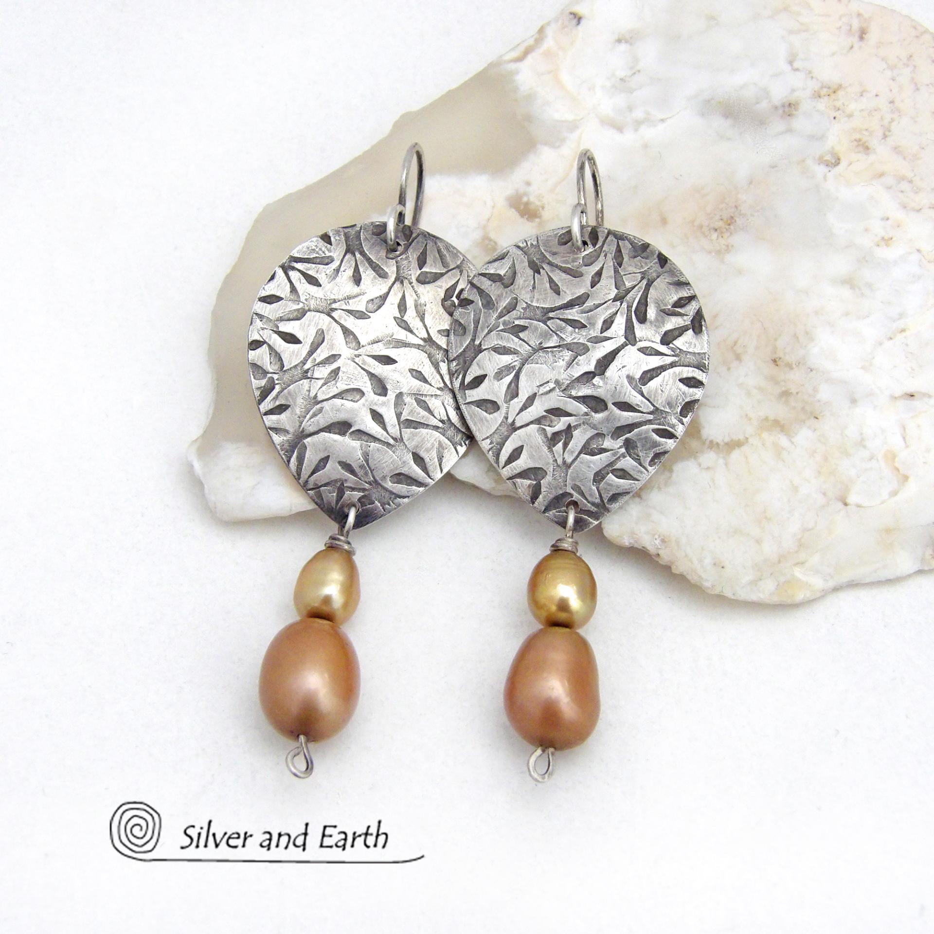 These artisan handcrafted sterling silver earrings have a hand stamped texture and are accented with a stack of dangling 2-tone gold freshwater pearls. They have a modern, contemporary style that looks good with all wardrobe styles -dressed up or down. They'll make a great gift for women that love unique handmade jewelry. 
