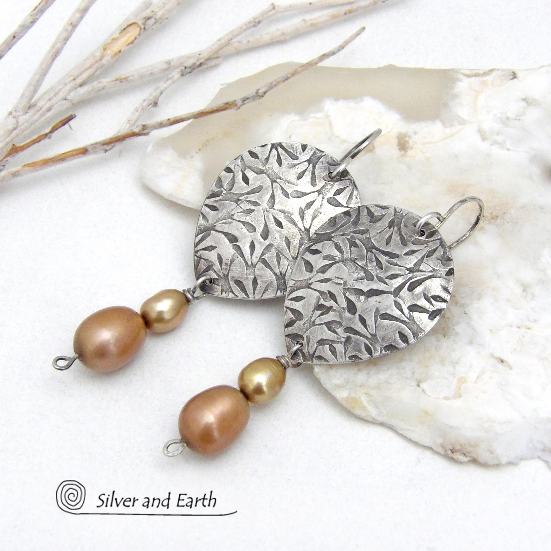 These artisan handcrafted sterling silver earrings have a hand stamped texture and are accented with a stack of dangling 2-tone gold freshwater pearls. They have a modern, contemporary style that looks good with all wardrobe styles -dressed up or down. They'll make a great gift for women that love unique handmade jewelry. 