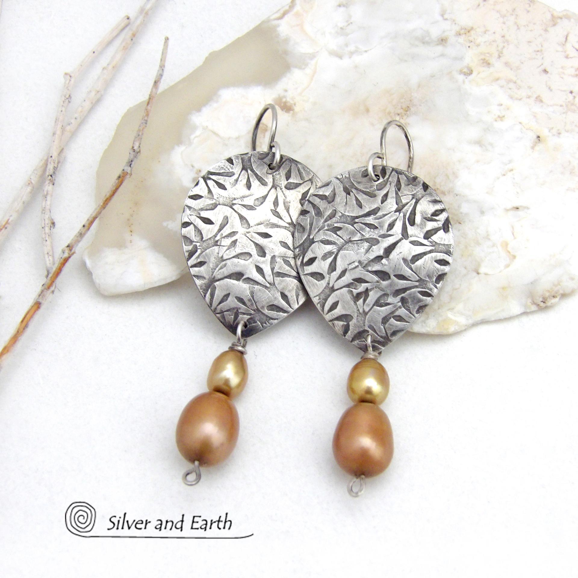 These artisan handcrafted sterling silver earrings have a hand stamped texture and are accented with a stack of dangling 2-tone gold freshwater pearls. They have a modern, contemporary style that looks good with all wardrobe styles -dressed up or down. They'll make a great gift for women that love unique handmade jewelry. 