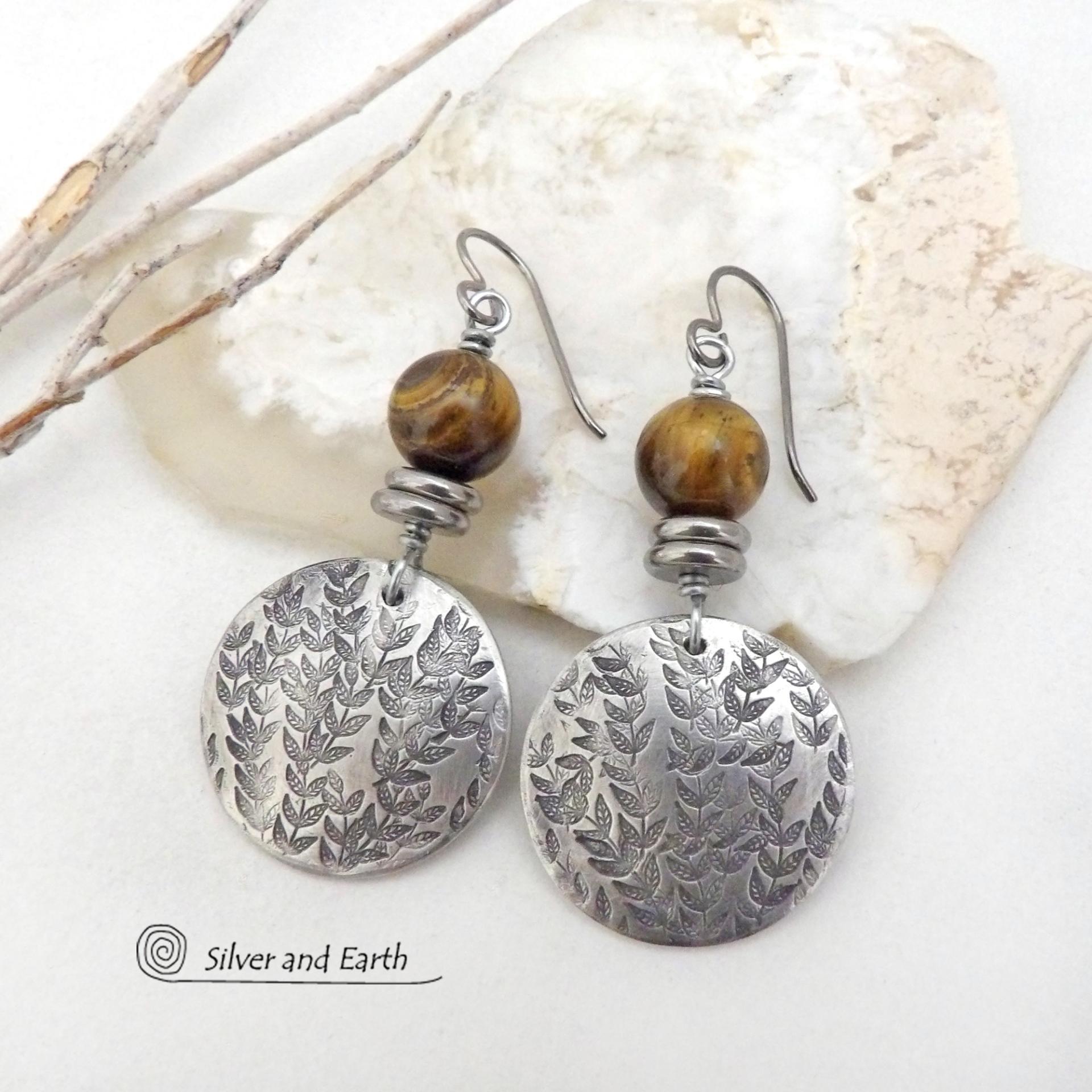 These artisan handcrafted silver pewter earrings feature a hand stamped leaf design and are accented with brown tiger's eye gemstones and stainless steel beads. They have an earthy, modern and elegant style that coordinates beautifully with all wardrobe types. They'll make a great gift for a nature lover - or a nice addition to your own jewelry wardrobe.