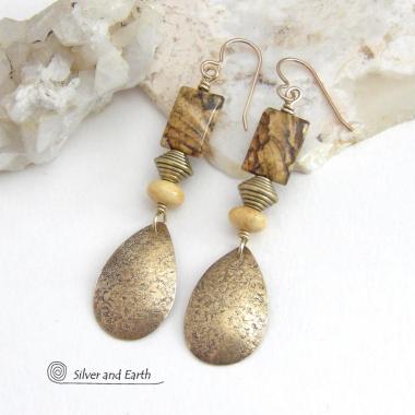 These handcrafted earrings feature gold brass teardrop dangles with a lightly hammered organic texture accented with natural picture jasper stones, brass and fossilized beige coral beads. They have an earthy natural style that coordinates beautifully with all wardrobe styles. Earrings have a coordinating necklace sold separately. Handmade in the USA by Silver and Earth Jewelry.