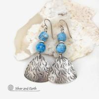 These handcrafted sterling silver dangle earrings have a hand stamped texture and are accented with natural apatite gemstones. The stones have a beautiful blue hue and the ones on top have a faceted nugget finish. They have an elegant, modern style that looks great with all wardrobe styles - dressed up or down.