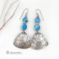 These handcrafted sterling silver dangle earrings have a hand stamped texture and are accented with natural apatite gemstones. The stones have a beautiful blue hue and the ones on top have a faceted nugget finish. They have an elegant, modern style that looks great with all wardrobe styles - dressed up or down.