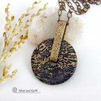 This one-of-a-kind pendant necklace features a stunning artistic jasper stone accented with a hand forged gold brass bail. This type of jasper is known for its intricate, natural patterns that resemble brushstrokes, landscapes, or abstract art. The stone in this piece has a natural bold dramatic pattern in hues of black and soft golden yellow with black streaks that resemble "feathery" dendrites. The design is modern and bold - yet classic and always in fashion. It can be worn by either a man or women. 