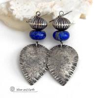 Big and bold - these earrings feature handcrafted sterling silver dangles with a rustic, organic texture accented with chunky natural blue lapis lazuli gemstones and Native style oxidized sterling silver beads with a rich, corrugated texture. They have a modern southwestern and tribal flair that makes a bold statement. Perfect for women that love artisan handcrafted southwest Santa Fe style jewelry. Handmade in the USA by Silver and Earth Jewelry - a New Mexico True Certified Business. 