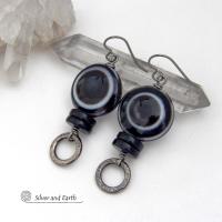 These earrings feature big natural black eye agate stones accented with black onyx and small hammered silver pewter circle dangles. When cut at the right angle, this type of agate reveals a series of concentric rings that resembles the human eye. They have a funky, modern vibe and are unique and fun to wear. They'll make a bold statement and are perfect for women that love to wear unique natural stone jewelry. 