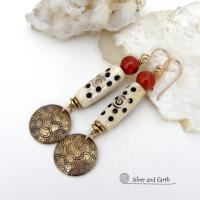 These handcrafted earrings feature a carved African bone beads, red jasper gemstones and textured gold brass dangles. Unique and striking, they have a boho chic style with lots of tribal flair. Perfect for women that love to wear bold unique artisan handmade jewelry. Handmade in the USA by Silver and Earth Jewelry. 