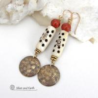 These handcrafted earrings feature a carved African bone beads, red jasper gemstones and textured gold brass dangles. Unique and striking, they have a boho chic style with lots of tribal flair. Perfect for women that love to wear bold unique artisan handmade jewelry. Handmade in the USA by Silver and Earth Jewelry. 