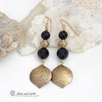 These handcrafted earrings feature gold brass dangles with a hammered raw silk texture accented with black onyx gemstones and brass beads. They have a modern boho chic style with a touch of Egyptian inspired flair that coordinates beautifully with all wardrobe types. Perfect for women that love artisan handcrafted jewelry that makes a bold statement. Handmade in the USA by Silver and Earth Jewelry. 