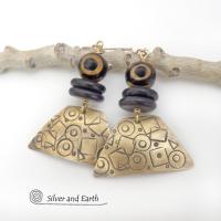 These artisan handcrafted earrings are perfect for women that love bold statement jewelry with an exotic flair. They feature gold brass dangles with an abstract hand stamped texture accented with brown and black Tibetan eye agate and black agate stones. Bold and unique - with an ethic tribal style - they'll make a striking statement.