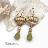Bold and unique, these handcrafted earrings have an exotic bohemian style with a touch of Egyptian flair. They feature gold brass with a hammered and stamped texture accented with teardrop-shaped natural green jade gemstones and brass beads. Perfect for women that love to wear unique artisan handcrafted jewelry. Total length of approximately 2-3/8" from top of brass ear wires and 1" at widest point. Handmade in the USA by Silver and Earth Jewelry. 