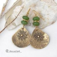 These handcrafted gold brass earrings have an earthy and modern nature-inspired charm. The design consists of brass fan-shaped dangles accented with Canadian green jade gemstones, brass flower charms and brass beads. The flowers have a lovely detailed texture and swing freely in front of the lightly hammered brass dangles. Perfect for your spring / summer wardrobe - or any time of year. They'll make a great gift for a nature and/or flower lover - or a nice addition to your own jewelry wardrobe. 