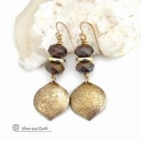 These handcrafted earrings feature gold brass dangles with a hammered organic texture accented with natural bronzite gemstones and shiny gold brass beads. The stones have a beautiful brown hue with a faceted finish which casts off a natural sparkle and shine. They have a modern chic style that coordinates beautifully with all wardrobe types - dressed up or down. A coordinating necklace is available that is sold separately.  Handmade in the USA by Silver and Earth Jewelry.