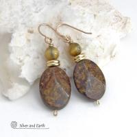 These handcrafted earrings feature natural bronzite gemstones with a faceted finish accented with golden tiger's eye gemstones and shiny brass beads. The bronzite stones have a beautiful chocolate brown hue with subtle *gold tone* metallic inclusions. Bronzite is a blend of several minerals which gives it a unique mottled appearance. They have a modern, earthy appeal and will make a great gift for a nature lover - or an interesting addition to your own jewelry wardrobe. Handmade in the USA by Silver and Ear