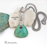 This one-of-a-kind pendant necklace features a beautiful chunky natural chrysocolla gemstone with a faceted finish. The stone is a beautiful shade of bluish-green which resembles turquoise. It hangs from a hand forged solid sterling silver bail with a lightly hammered organic texture. It's reversible. Unique and one-of-a-kind, it's sure to make a statement. Handmade in the USA by Silver and Earth Jewelry.