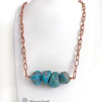 This chunky turquoise necklace features big, organically-shaped nuggets of genuine natural turquoise accented with a copper link chain. The turquoise is a stunning shade of blue - reminiscent of the lovely blue skies here in the American Southwest. Unique and one-of-a-kind, it will make a bold statement. Perfect for women that love bold unique jewelry made with natural stones. Handmade in the USA by Silver and Earth Jewelry. 