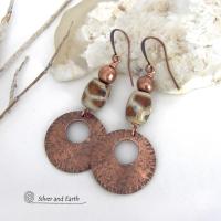 These handcrafted copper earrings have a bold, ethnic African style and flair. They feature round copper dangles with a rustic hammered texture accented with African etched giraffe print agate stones topped off with solid copper beads. Unique and striking, they'll make a bold statement. Perfect for women that love ethnic tribal style jewelry. Handmade in the USA by Silver and Earth Jewelry. 