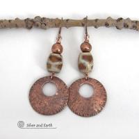 These handcrafted copper earrings have a bold, ethnic African style and flair. They feature round copper dangles with a rustic hammered texture accented with African etched giraffe print agate stones topped off with solid copper beads. Unique and striking, they'll make a bold statement. Perfect for women that love ethnic tribal style jewelry. Handmade in the USA by Silver and Earth Jewelry. 