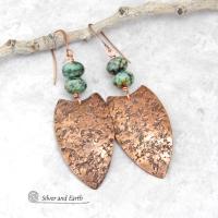 These large copper earrings feature handcrafted copper shields with a rustic, organic hammered texture accented with earthy, natural African turquoise stones. Big and bold, they have an ethnic tribal vibe and will make a striking statement. 